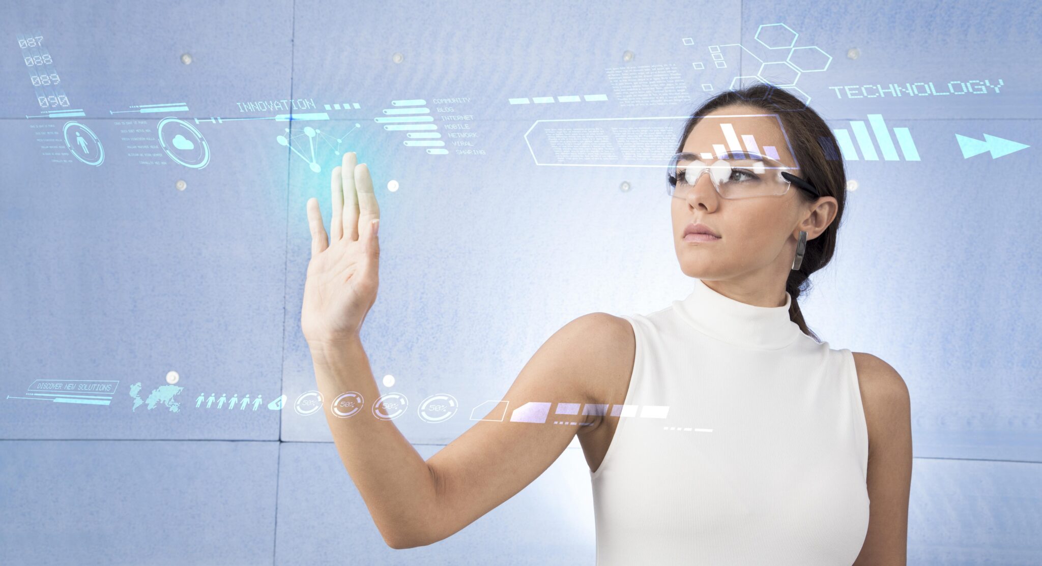 A young brunette woman in a white high-tech dress is wearing smart glasses and pressing her hand up against a holographic screen